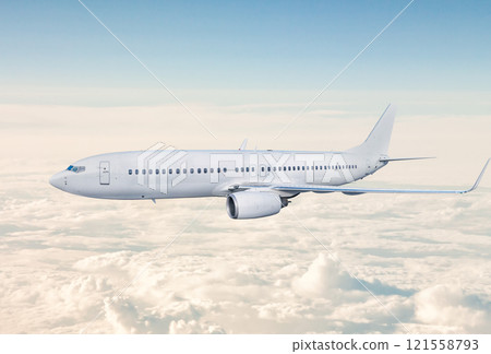 White passenger jet plane fly in the air above the clouds 121558793
