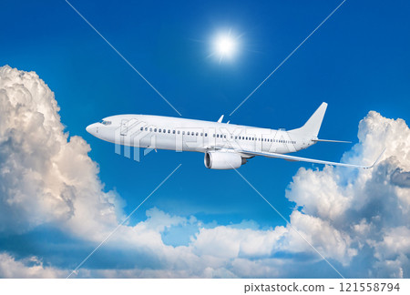 White passenger airliner fly in the air above scenic clouds White passenger airliner fly in the air above scenic clouds 121558794
