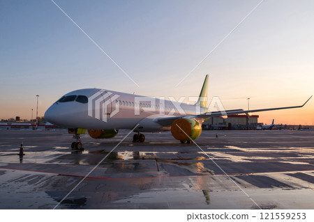 Modern passenger airplane on the airport apron at the evening light Modern passenger airplane on the airport apron at the evening light 121559253