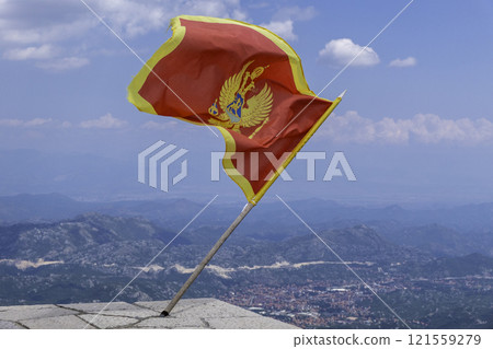 Montenegro, Flag of Montenegro flying over the Njegos Mausoleum. Montenegro, Flag of Montenegro flying over the Njegos Mausoleum. 121559279