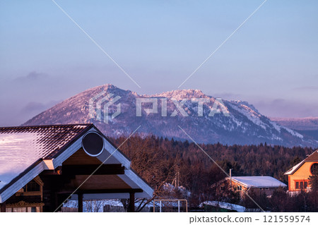 Mountains, forest and village on a winter evening 121559574
