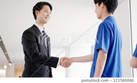 A caregiver and a welfare equipment specialist shaking hands A caregiver and a welfare equipment specialist shaking hands 121560086