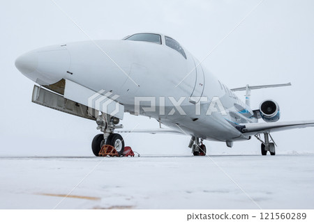 Close-up of the luxury private jet on the winter airport apron 121560289
