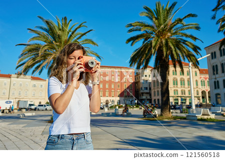 Young Woman Taking Photos in Coastal Town Young Woman Taking Photos in Coastal Town 121560518