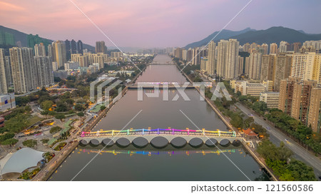Colorful Illuminated Pedestrian Bridge Above Calm Water at Dusk Dec 22 2024 121560586