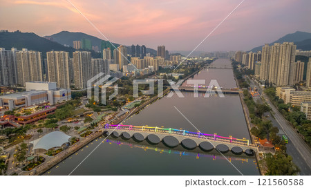 Colorful Illuminated Pedestrian Bridge Above Calm Water at Dusk Dec 22 2024 121560588
