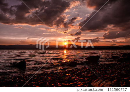 Scenic crimson sunset on a beautiful lake Scenic crimson sunset on a beautiful lake 121560737