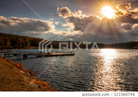 Picturesque lake with a pier on an autumn day 121560748