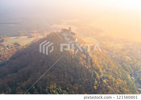 Bezdez medieval castle majestically towers over the colorful autumn landscape, offering a stunning aerial perspective of its historic architecture surrounded by vibrant fall foliage. Bezdez medieval castle majestically towers over the colorful autumn landscape, offering a stunning aerial perspective of its historic architecture surrounded by vibrant fall foliage. 121560801