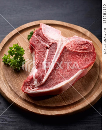 Raw t-bone beef on the wooden plate 121561120