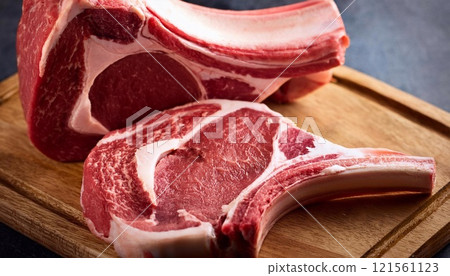 Raw t-bone beef on the wooden plate 121561123