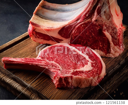 Raw t-bone beef on the wooden plate Raw t-bone beef on the wooden plate 121561138
