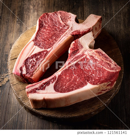 Raw t-bone beef on the wooden plate 121561141
