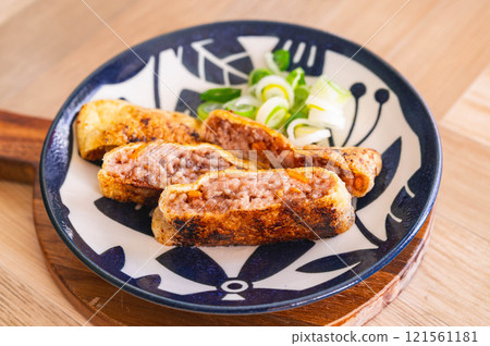 Deep fried minced meat and vegetable wrap 121561181