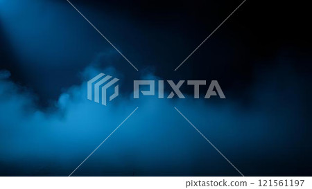 A beam of cold blue spotlight on a dark, empty stage, the room shrouded in a thick layer of blue fog. An abstract combination of smoke textures and lighting 121561197