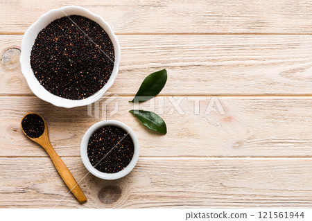 quinoa seeds in bowl and spoon on colored background. Healthy kinwa in small bowl. Healthy superfood 121561944