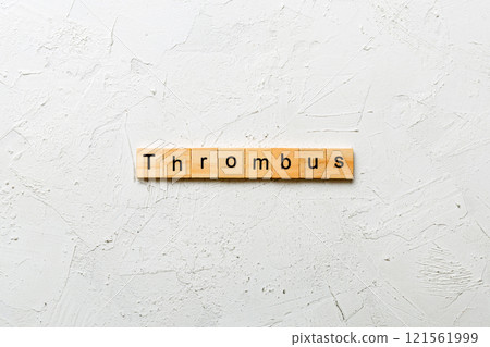 thrombus word written on wood block. thrombus text on table, concept 121561999