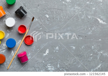 art palette with paint and brushes, close up. Top view with empty space. workplace for creativity. home teaching concept drawing art palette with paint and brushes, close up. Top view with empty space. workplace for creativity. home teaching concept drawing 121562145