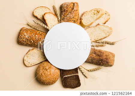 Minimalist paper blank mockup on background of Types of homemade bread. Different kinds of fresh bread as background, top view with space for your text or design 121562164