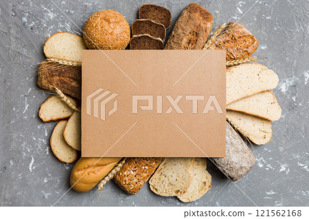 Minimalist paper blank mockup on background of Types of homemade bread. Different kinds of fresh bread as background, top view with space for your text or design 121562168