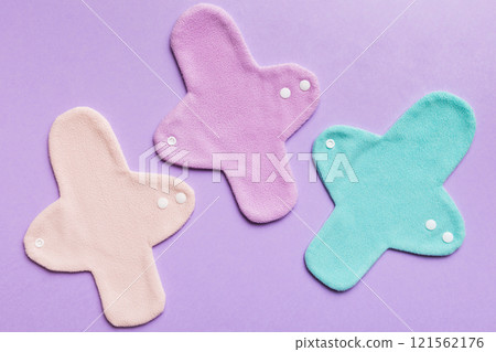 Eco-friendly reusable fabric women's pads. set of colorful bright reusable menstrual pads. zero waste woman periods concept top view with copy space Eco-friendly reusable fabric women's pads. set of colorful bright reusable menstrual pads. zero waste woman periods concept top view with copy space 121562176