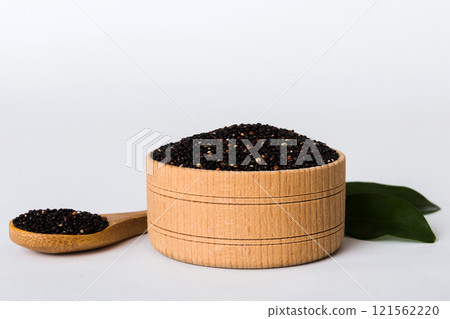 quinoa seeds in bowl and spoon on colored background. Healthy kinwa in small bowl. Healthy superfood 121562220