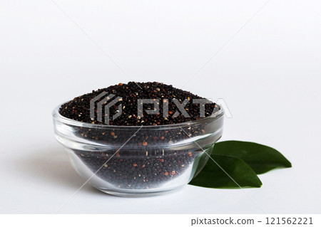 quinoa seeds in bowl on colored background. Healthy kinwa in small bowl. Healthy superfood quinoa seeds in bowl on colored background. Healthy kinwa in small bowl. Healthy superfood 121562221