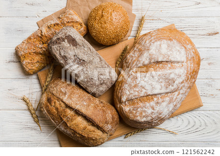 Assortment of freshly baked bread with napkin on rustic table top view. Healthy unleavened bread. French bread 121562242