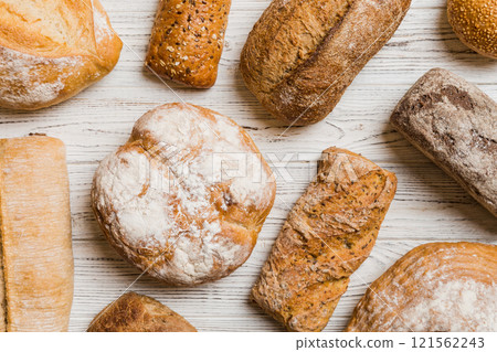 Homemade natural breads. Different kinds of fresh bread as background, top view with copy space Homemade natural breads. Different kinds of fresh bread as background, top view with copy space 121562243
