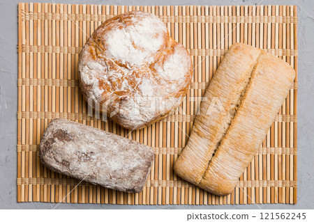 Assortment of freshly baked bread with napkin on rustic table top view. Healthy unleavened bread. French bread 121562245