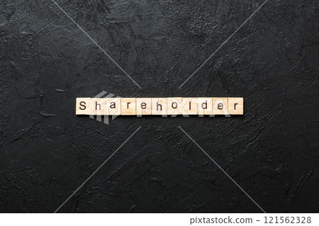 shareholder word written on wood block. shareholder text on table, concept 121562328