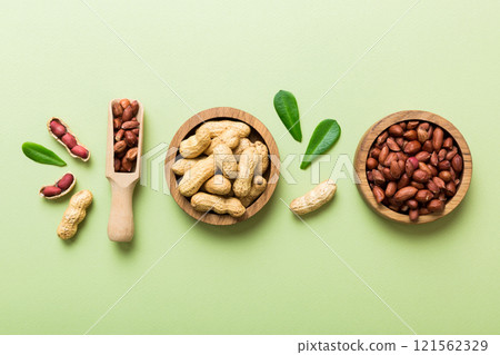 Fresh healthy peanuts in bowl on colored table background. Top view Healthy eating bertholletia concept. Super foods 121562329