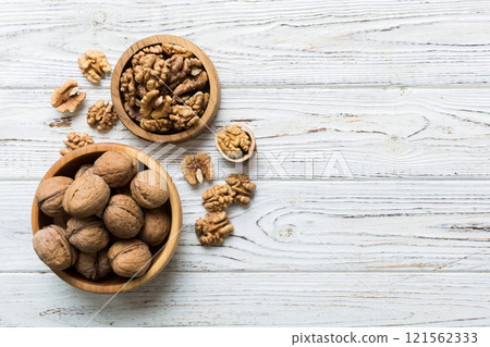 Fresh healthy walnuts in bowl on colored table background. Top view Healthy eating bertholletia concept. Super foods 121562333