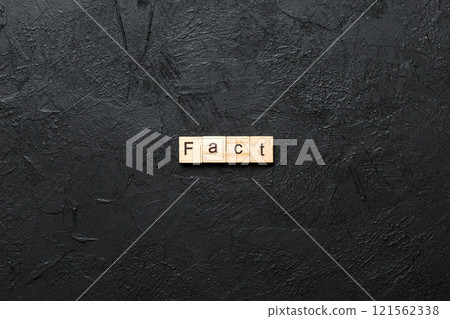 fact word written on wood block. fact text on table, concept 121562338