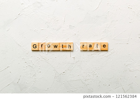 growth rate word written on wood block. growth rate text on cement table for your desing, concept growth rate word written on wood block. growth rate text on cement table for your desing, concept 121562384