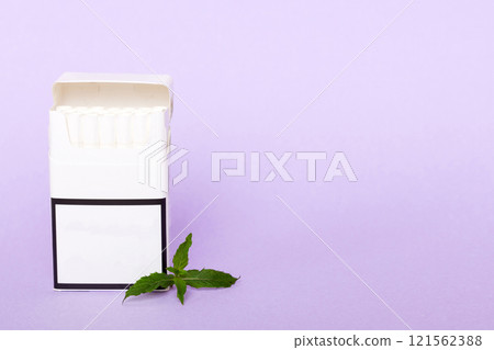 Pack of menthol cigarettes and fresh mint on colored table, Menthol cigarettes top view flat lay Pack of menthol cigarettes and fresh mint on colored table, Menthol cigarettes top view flat lay 121562388