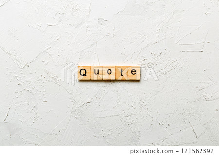 Quote word written on wood block. Quote text on cement table for your desing, concept 121562392