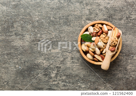 mixed nuts in bowl. Mix of various nuts on colored background. pistachios, cashews, walnuts, hazelnuts, peanuts and brazil nuts mixed nuts in bowl. Mix of various nuts on colored background. pistachios, cashews, walnuts, hazelnuts, peanuts and brazil nuts 121562400