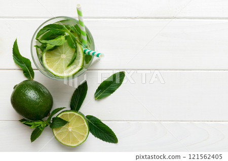 Caipirinha, Mojito cocktail, vodka or soda drink with lime, mint and straw on table background. Refreshing beverage with mint and lime in glass top view flat lay 121562405
