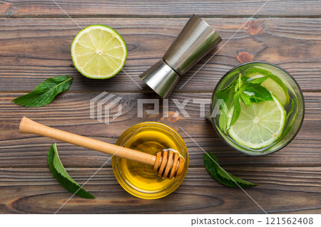Caipirinha, Mojito cocktail, vodka or soda drink with lime, mint and straw on table background. Refreshing beverage with mint and lime in glass top view flat lay 121562408