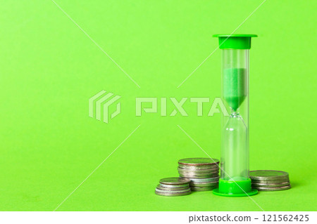 Deadline and time is money concept with hourglass and US coins currency. sand clock time for saving concept 121562425
