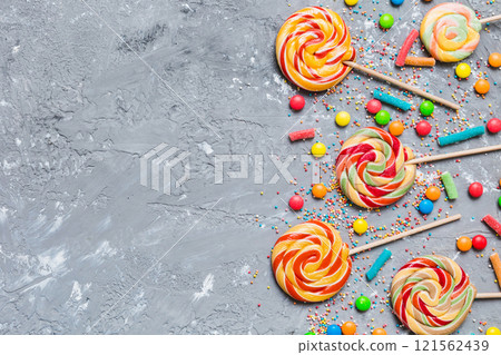 Tasty appetizing Party Accessories Happy Birthday Sweet. Different types of candies on colored background, copy space. Colorful birthday party background Tasty appetizing Party Accessories Happy Birthday Sweet. Different types of candies on colored background, copy space. Colorful birthday party background 121562439