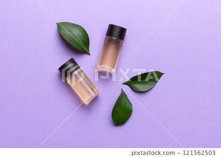 Organic cosmetic products with green leaves on color background 121562503
