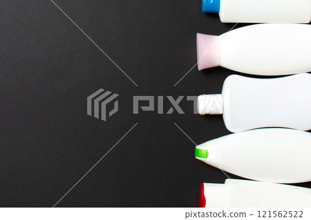 Top view of cosmetic products in different jars and bottles on colored background. Close-up of containers with copy space 121562522