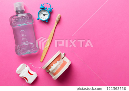 Mouthwash and other oral hygiene products on colored table top view with copy space. Flat lay. Dental hygiene. Oral care kit. Dentist concept Mouthwash and other oral hygiene products on colored table top view with copy space. Flat lay. Dental hygiene. Oral care kit. Dentist concept 121562538