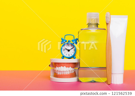 Mouthwash and other oral hygiene products on colored table top view with copy space. Flat lay. Dental hygiene. Oral care kit. Dentist concept Mouthwash and other oral hygiene products on colored table top view with copy space. Flat lay. Dental hygiene. Oral care kit. Dentist concept 121562539