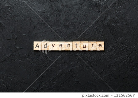 adventure word written on wood block. adventure text on cement table for your desing, concept 121562567