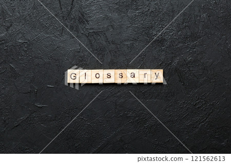 Glossary word written on wood block. Glossary text on cement table for your desing, Top view concept 121562613