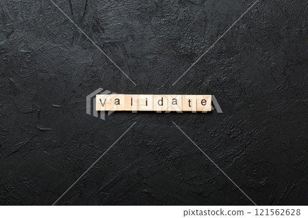 VALIDATE word written on wood block. VALIDATE text on cement table for your desing, concept VALIDATE word written on wood block. VALIDATE text on cement table for your desing, concept 121562628