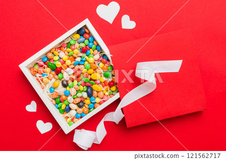 Valentine day composition: sweet candy, with gift boxes with bow and red felt hearts, photo template, background. Top View with copy space 121562717